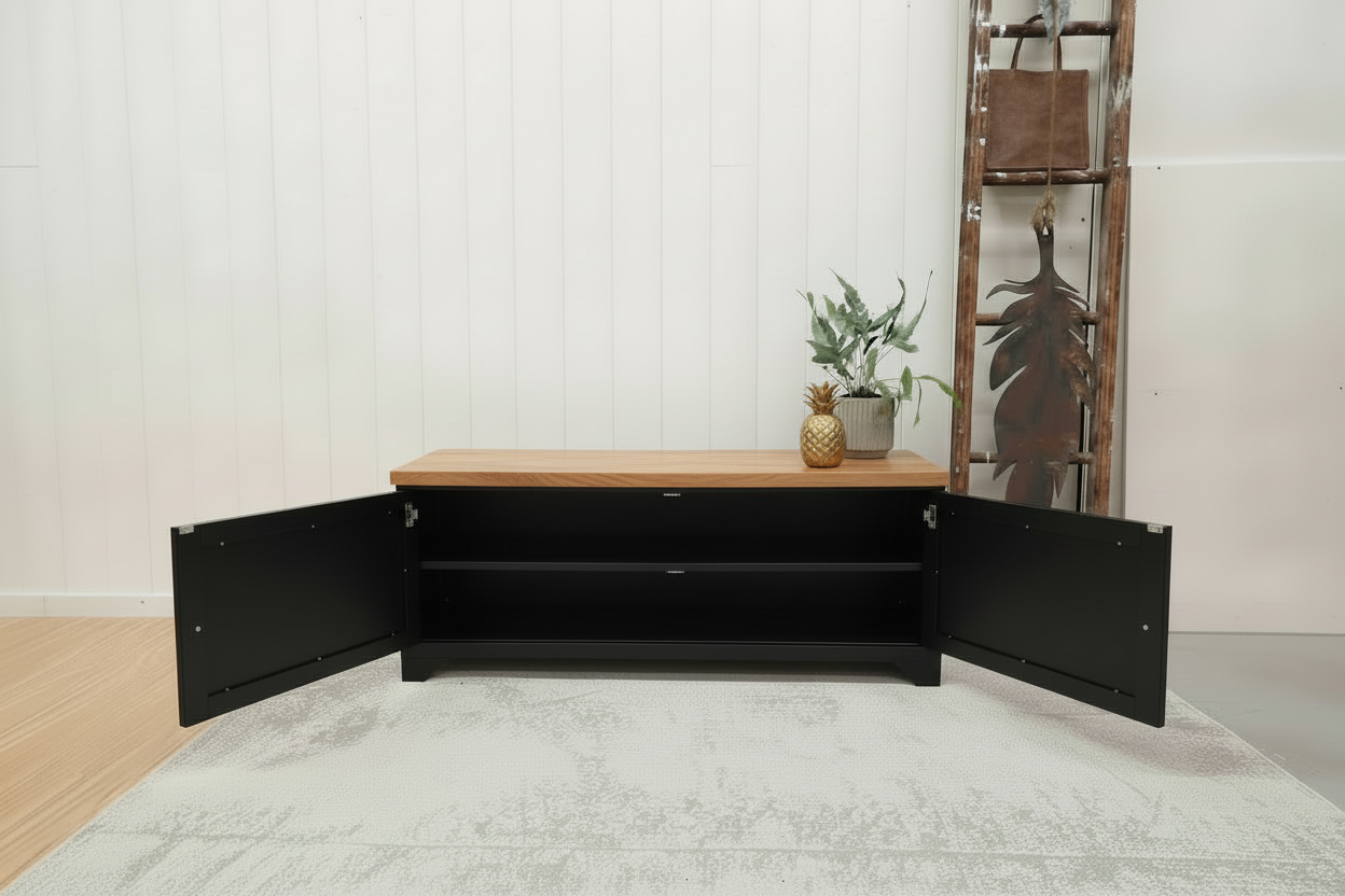 Black metal TV cabinet with no shelf in storage. Oak top