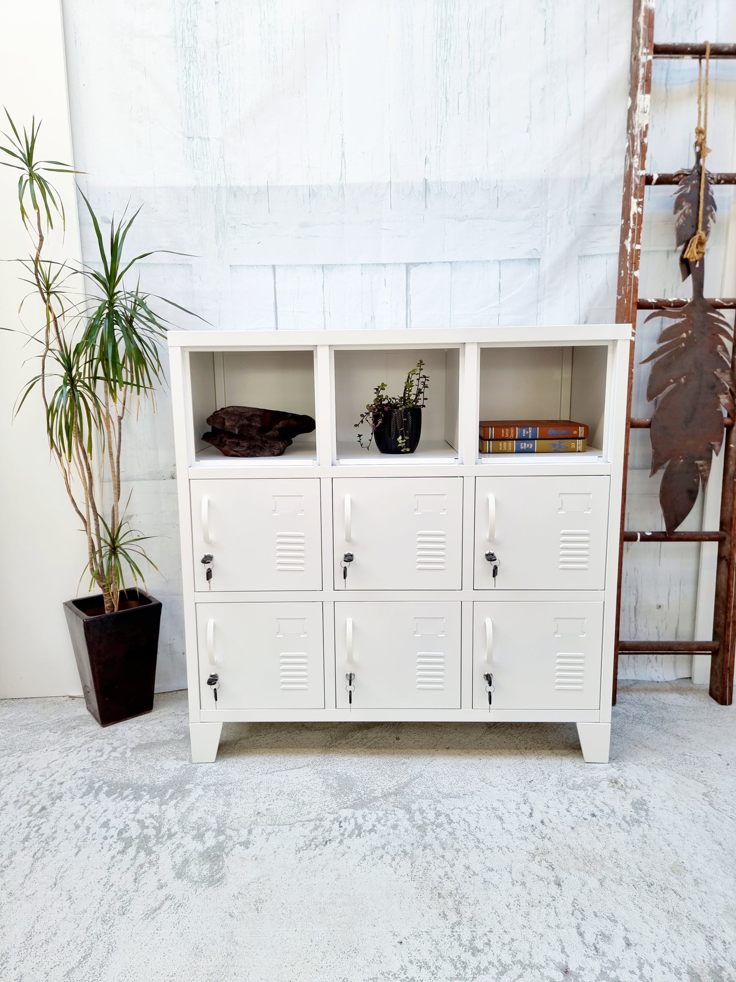 White metal industrial storage cabinet with shelves in a room setting