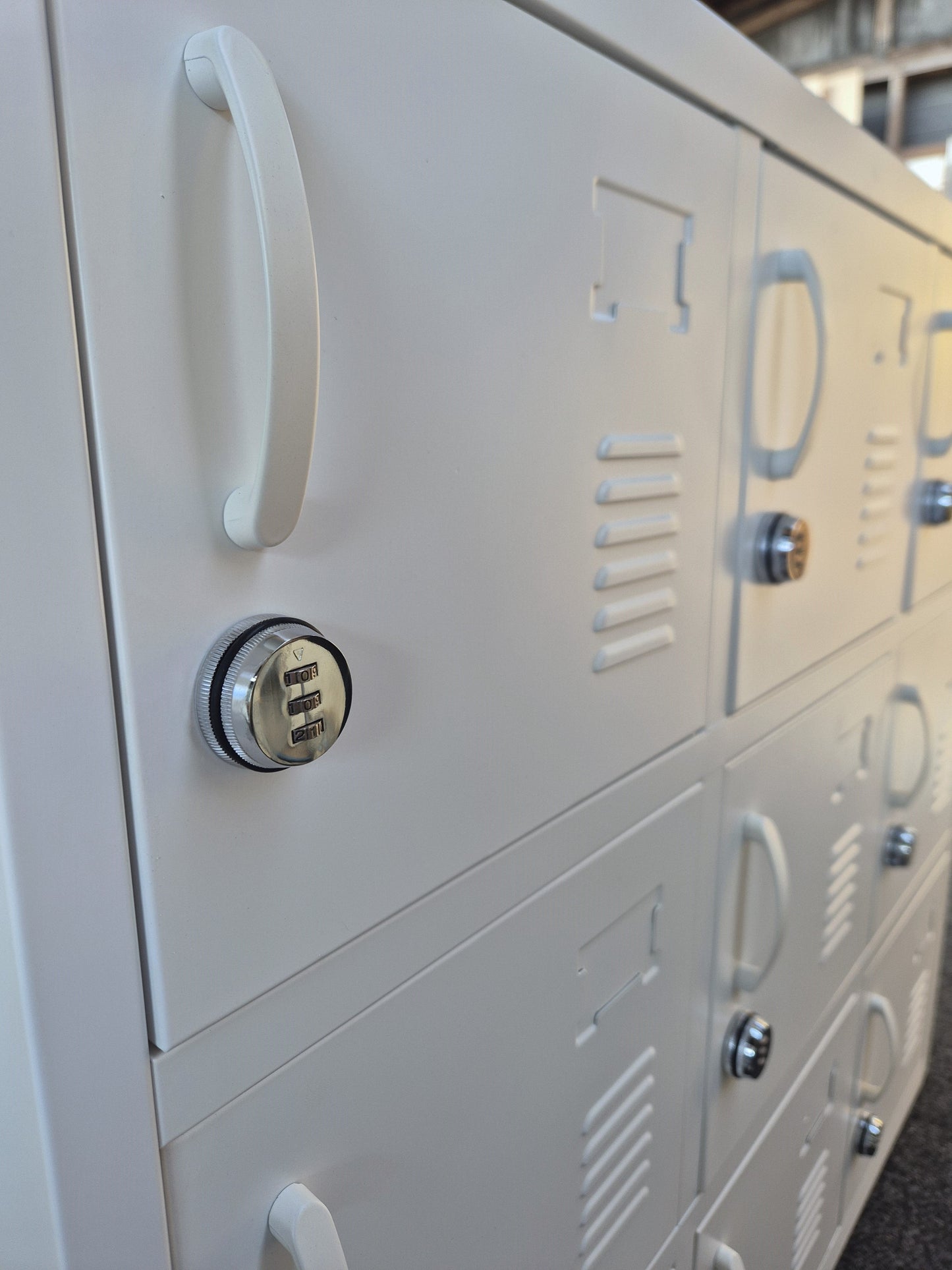 Close-up of a white locker with a combination lock