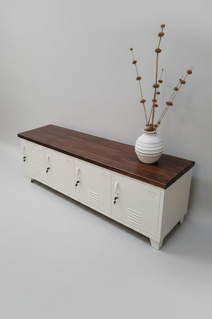 Wooden bench with white storage lockers and decorative items on a light gray floor.