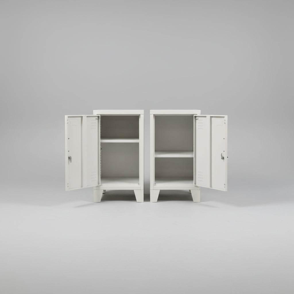 A pair of white metal mini locker cabinets with the doors open to show the adjustable shelf inside