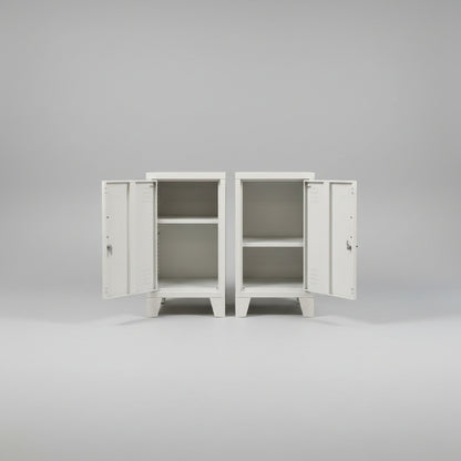 A pair of white metal mini locker cabinets with the doors open to show the adjustable shelf inside