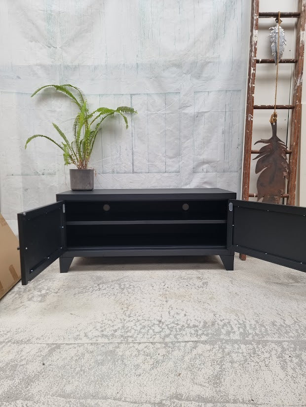 Black industrial metal TV cabinet with open doors showing in side an adjustable shelf and cable holes 