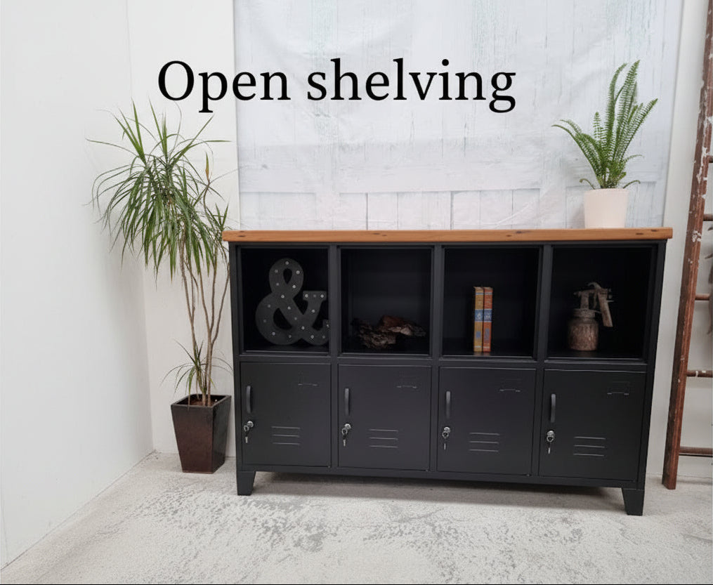 Black industrial metal locker-style cabinet with Rimu top open shelves and wooden top, featuring decorative items and plants.