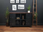 Black industrial metal sideboard with dark rimu top and open display shelves.