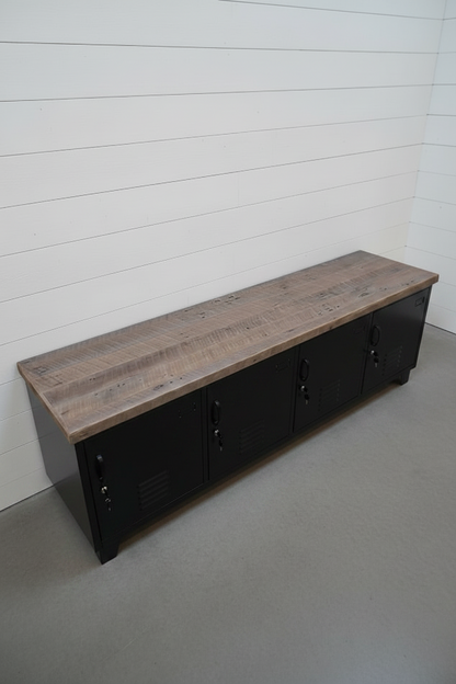 Black metal bench with storage lockers and rustic grey washed top against a white ship lap wall