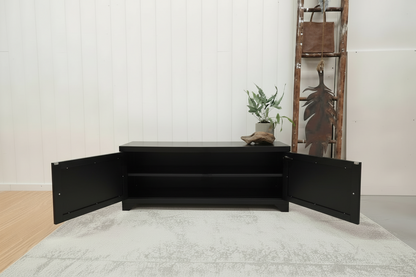 Black metal coffee table with open doors to show shelf inside