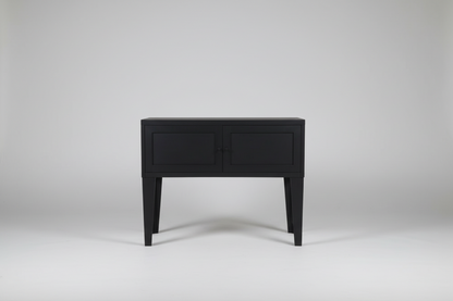 Black metal industrial side table on a white background