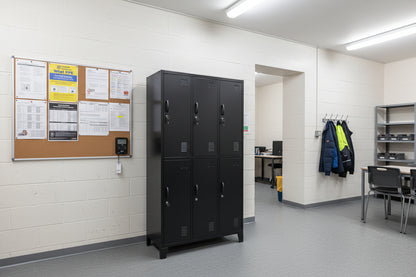 Black metal locker with six doors in a work room as staff lockers