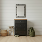 Black metal tallboy with Oak top in a room setting with shoes, bag, and decor items.