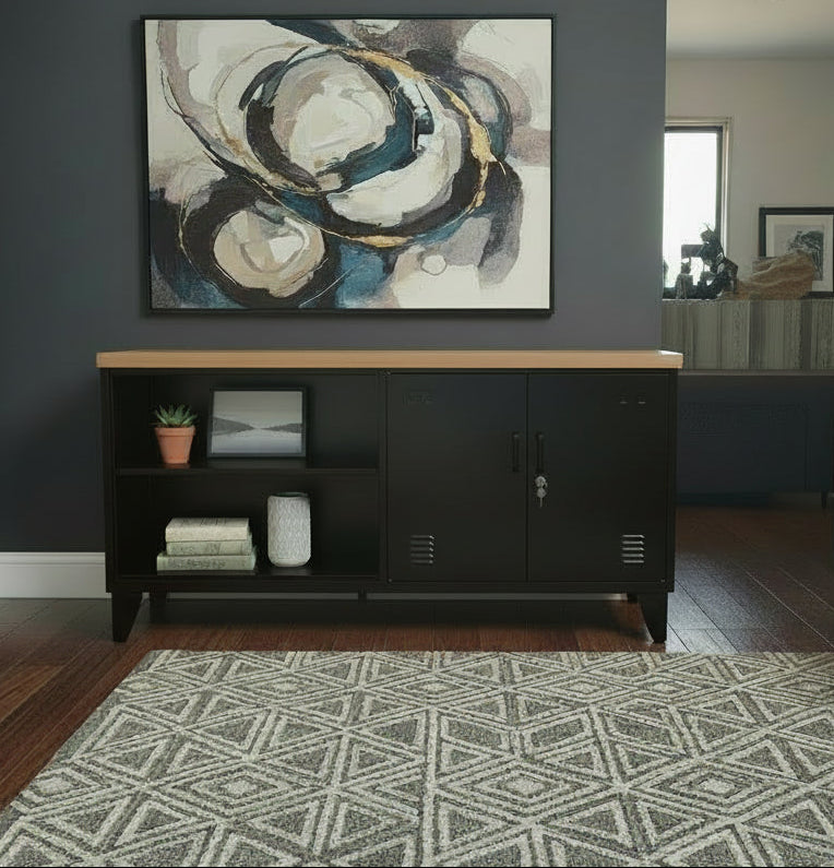 Black metal versatile cabinet with Rimu top in a room with plants and decor.