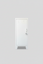 Narrow white metal side cabinet with a left hinge door