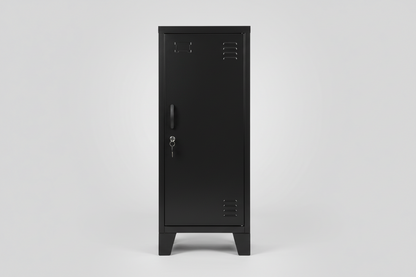 A Slim black metal side cabinet with right opening door, two adjustable shelves, placed on a floor with a potted plant and a ladder in the background.