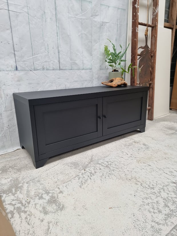 Small black Industrial metal TV cabinet with panel doors. Side angle view