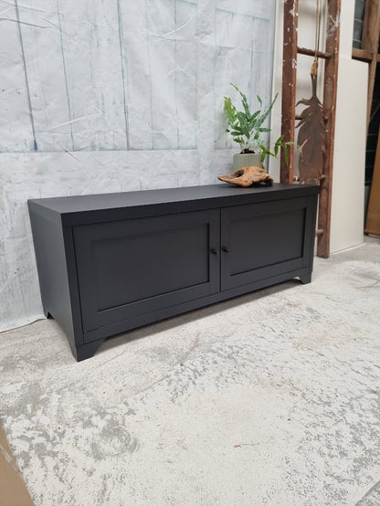 Small black Industrial metal TV cabinet with panel doors. Side angle view