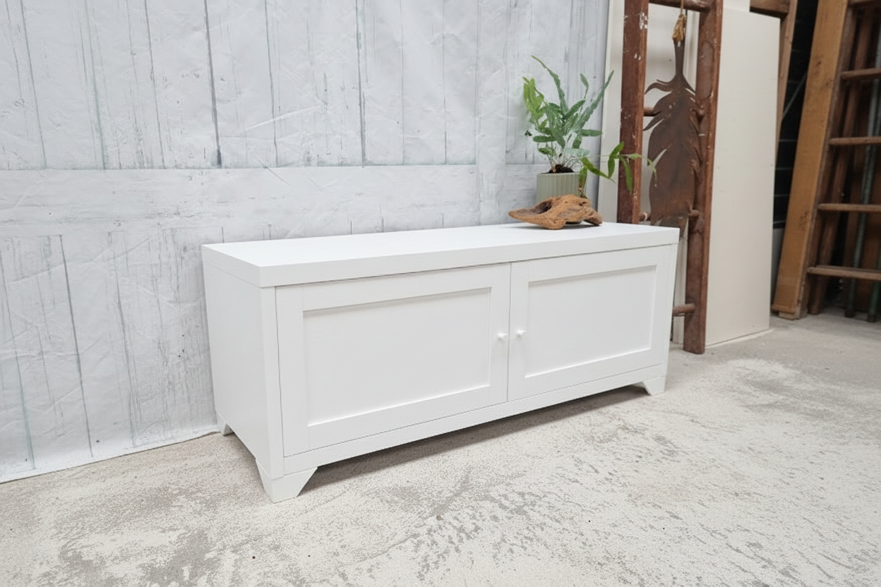 Small white Industrial metal TV cabinet with panel doors. Side angle view