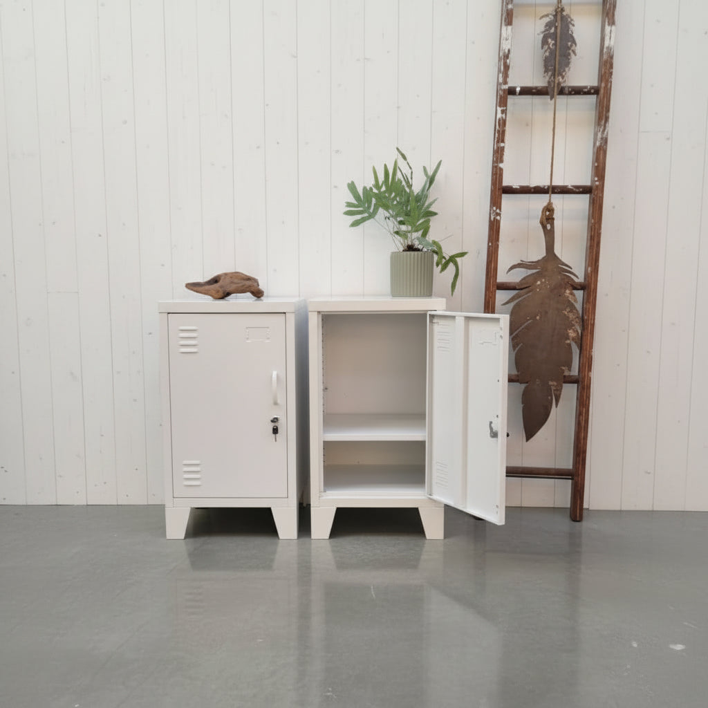 Two small vintage-style metal  lockers against a concrete wall with decorative elements.
