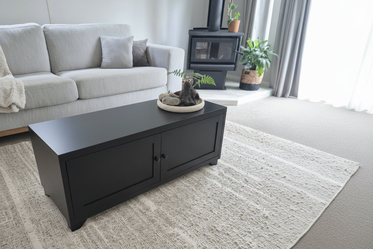 Living room with a white coffee table, gray sofa, and decorative items.