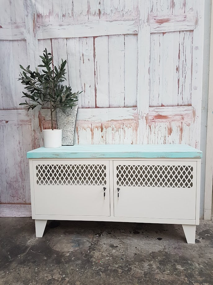 White Industrial metal TV cabinet with Tongue and groove turquoise top. Lockable storage with sytle