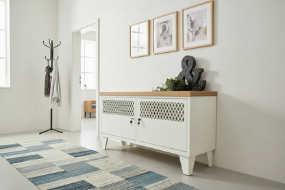 White metal sideboard with wooden top in a room with a coat rack, mirror, and decorative items.