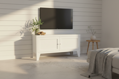 White industrial metal TV stand with a black TV against a white paneled wall in a room.