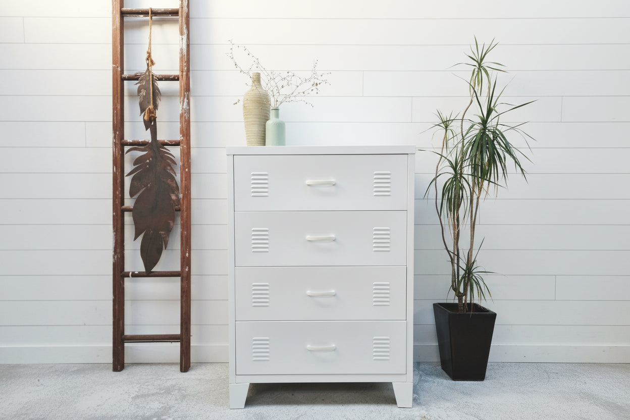 White industrial tallboy with 4 drawers in a room with plants and a ladder.