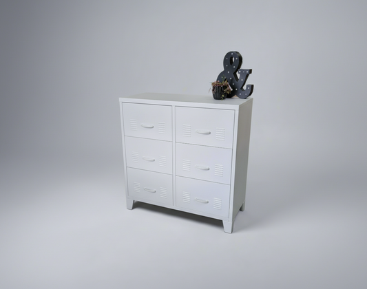 White metal 6 Drawer tallboy cabinet with decorative items on a gray background