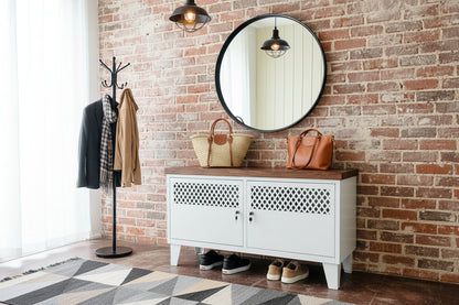 White metal TV cabinet with dark herringbone top as entryway cabinet for shoe and bag storage