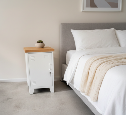 A White metal beside cabinets with recycled Rimu top in a bedroom