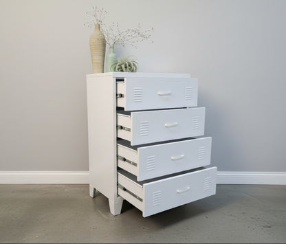 White metal dresser with 4 drawers open against a light-colored wall.