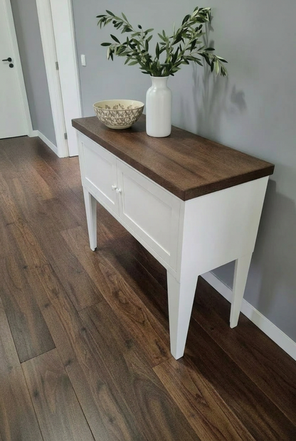 White metal hall cabinet with storage dark oak top in a hallway of modern house.