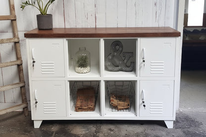 White locker-style cabinet with wooden top against a white wall.