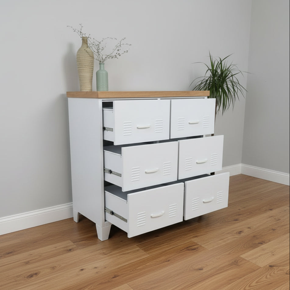 White metal tallboy drawers with Oak top and six big drawers against a light-colored wall.