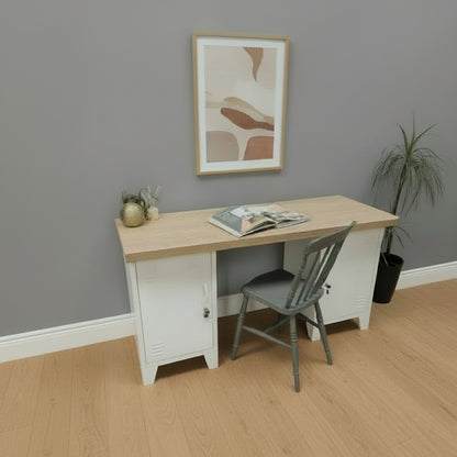 Wooden Oak desk with white metal locker base and a chair against a light gray wall.
