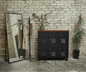 A black 6-door locker cabinet with dark wood top for home and office storage