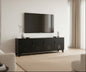 A black metal entertainment console in a modern living room with a television mounted on the wall above it.