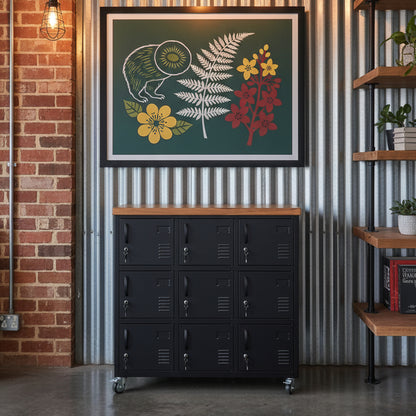 A black metal locker cabinet with nine lockable locker doors and a recycled Rimu top against a tin wall in an industrial office