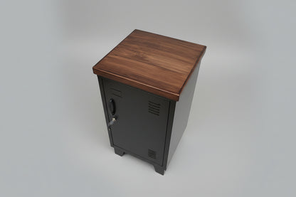 A black mini locker with a dark rimu top, featuring a right-open door, in plain background 