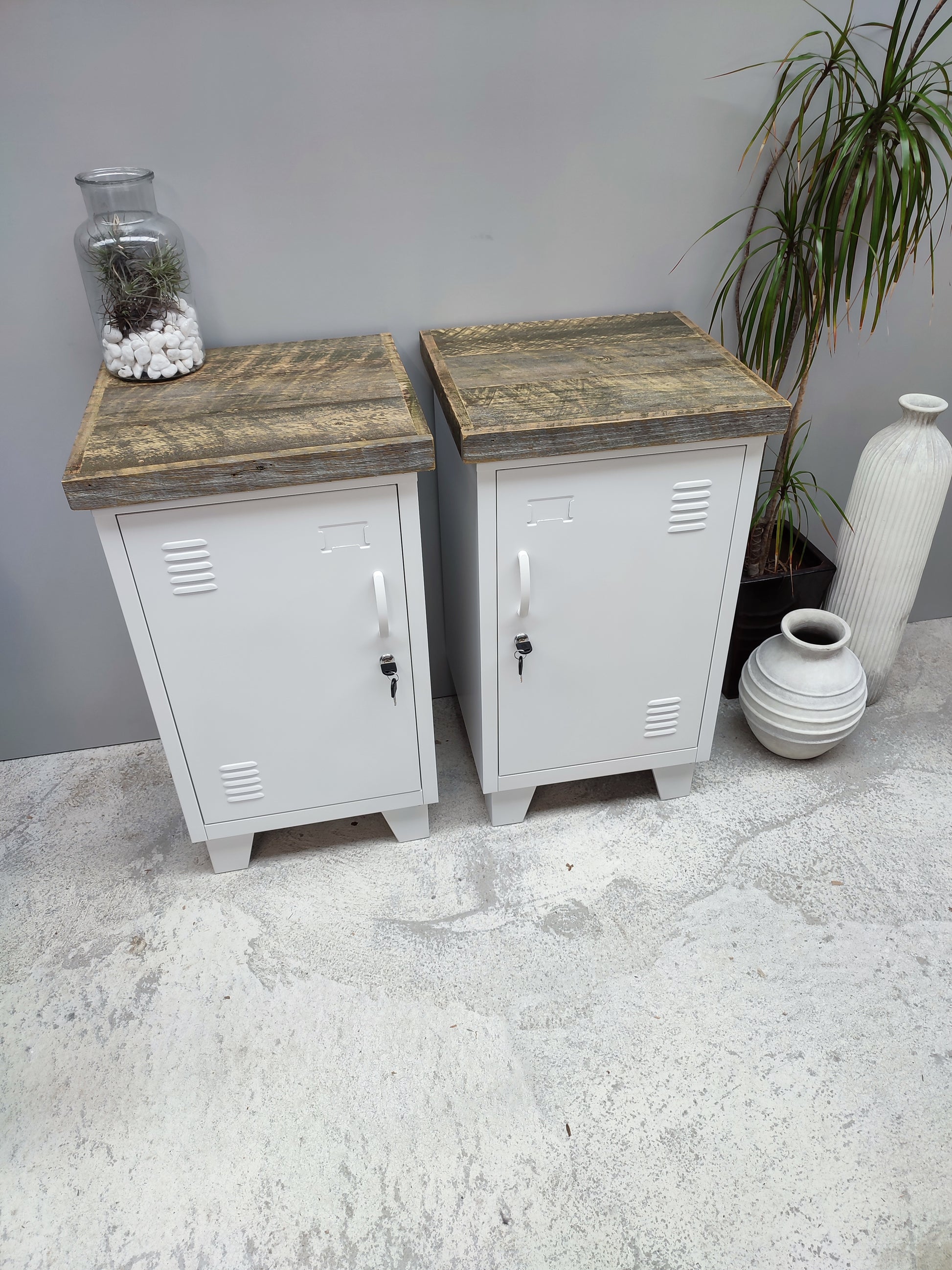 A pair of Small white metal cabinets with pallet tops