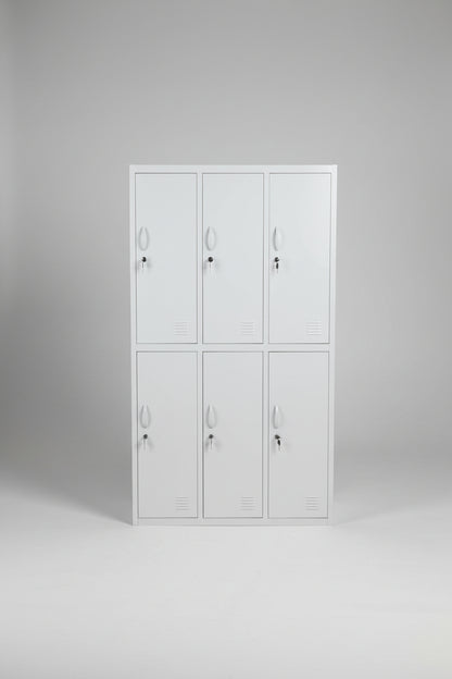 A tall white metal locker cabinet with six doors, shown standing in a warehouse or workshop environment.
