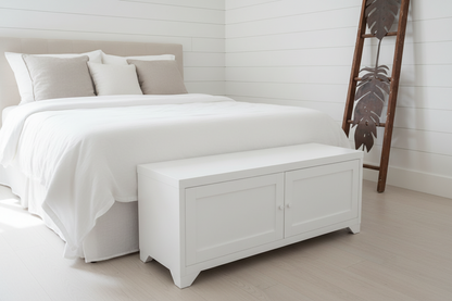 white metal coffee table with panel doors. Set at the end of bed, as end of bed storage
