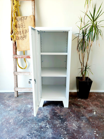 white metal side cabinet with a left hinge door open, showing adjustable shelves