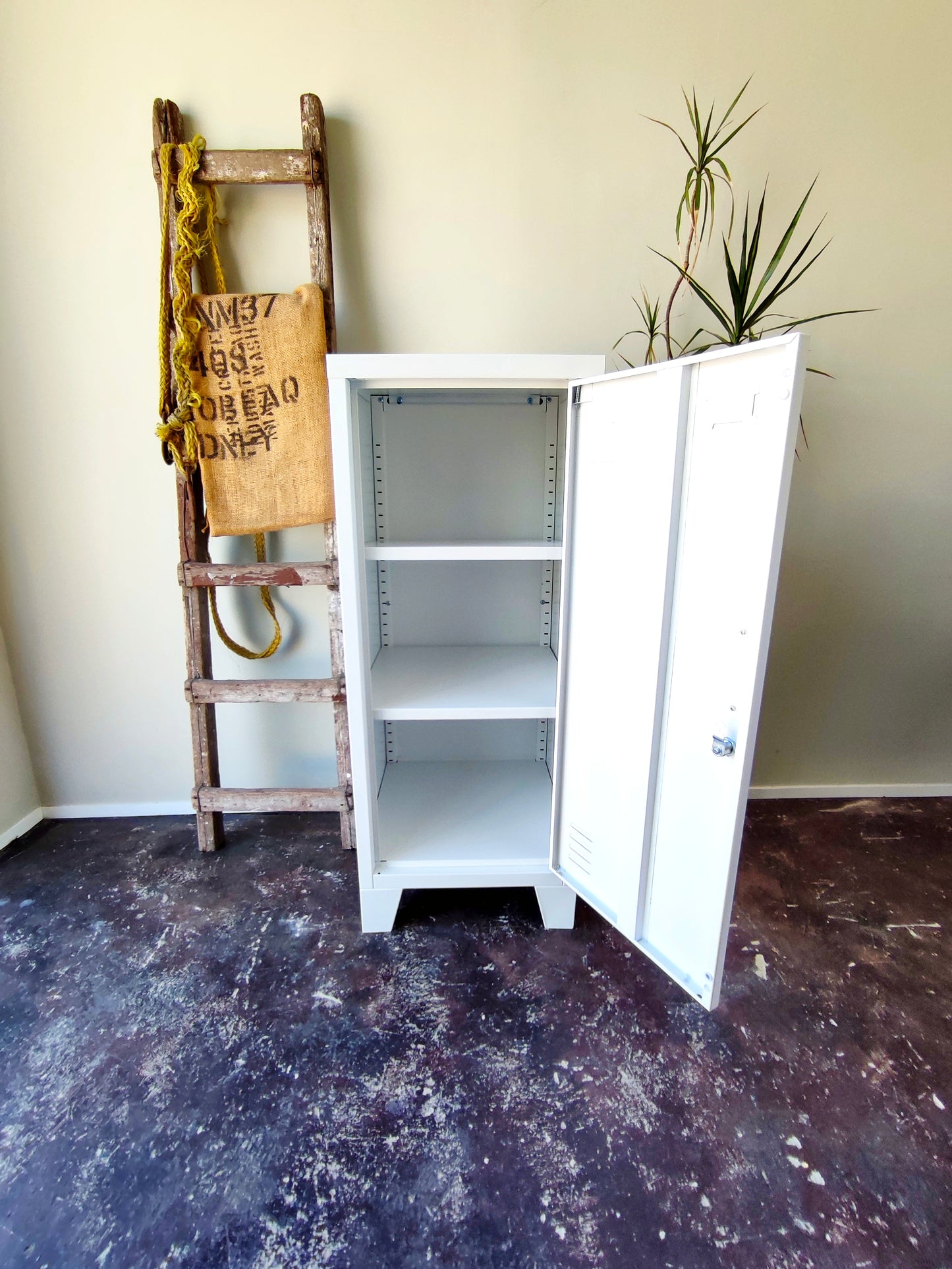 white metal side cabinet with a right hinge door open
