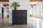 A black 6-door locker with a dark stained Rimu top, used for home storage