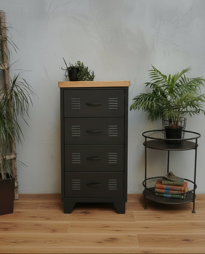 A black metal 4-drawer unit with an oak top, positioned in a room with various decor.