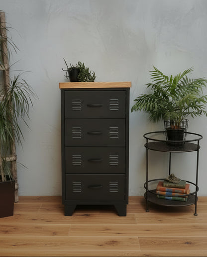 A black metal 4-drawer unit with an oak top, positioned in a room with various decor.