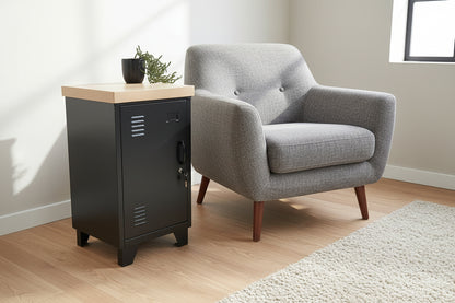 Black metal cabinet with a wooden top next to a grey chair against a white wall