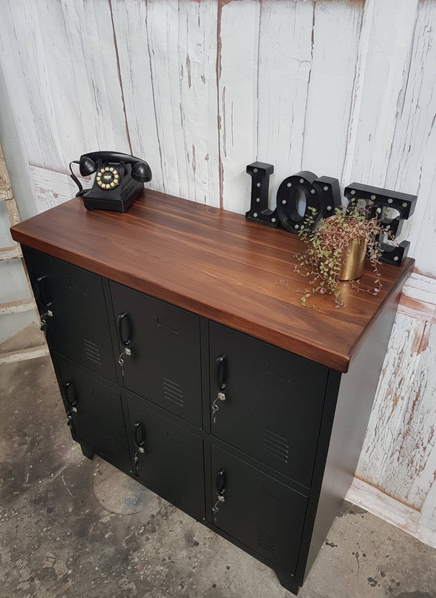 Black metal locker-style cabinet with Dark stained Rimu top against a rustic wall. Industrial style
