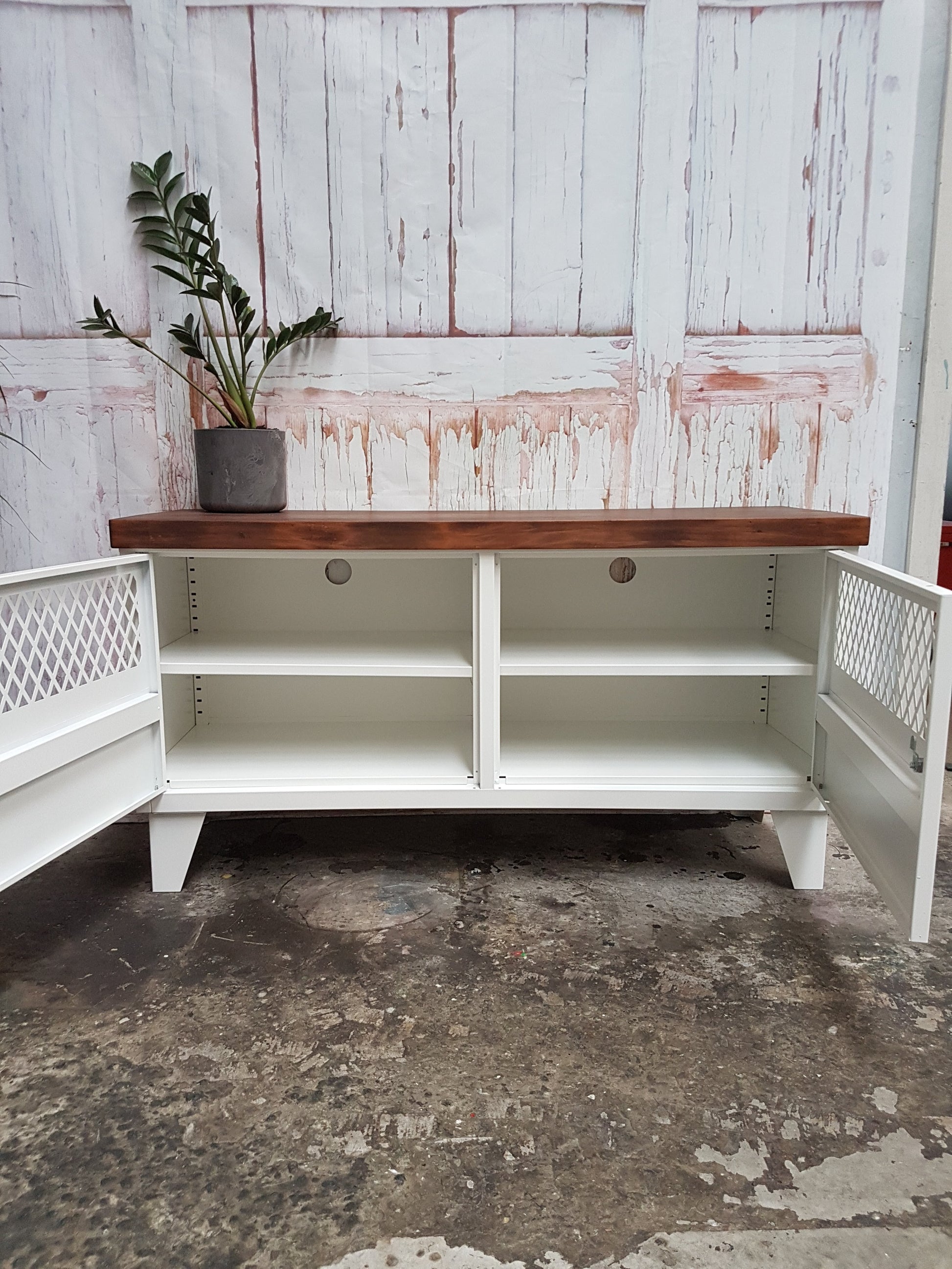 Industrial TV cabinet with dark stained recycled Rimu top with doors open to show adjustable shelves and cable holes