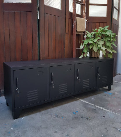 Large black metal TV cabinet with four doors in a industrial warehouse